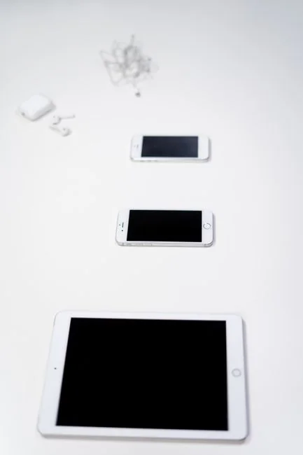 A modern workspace featuring dual computer monitors displaying web design projects, emphasizing technology and productivity.